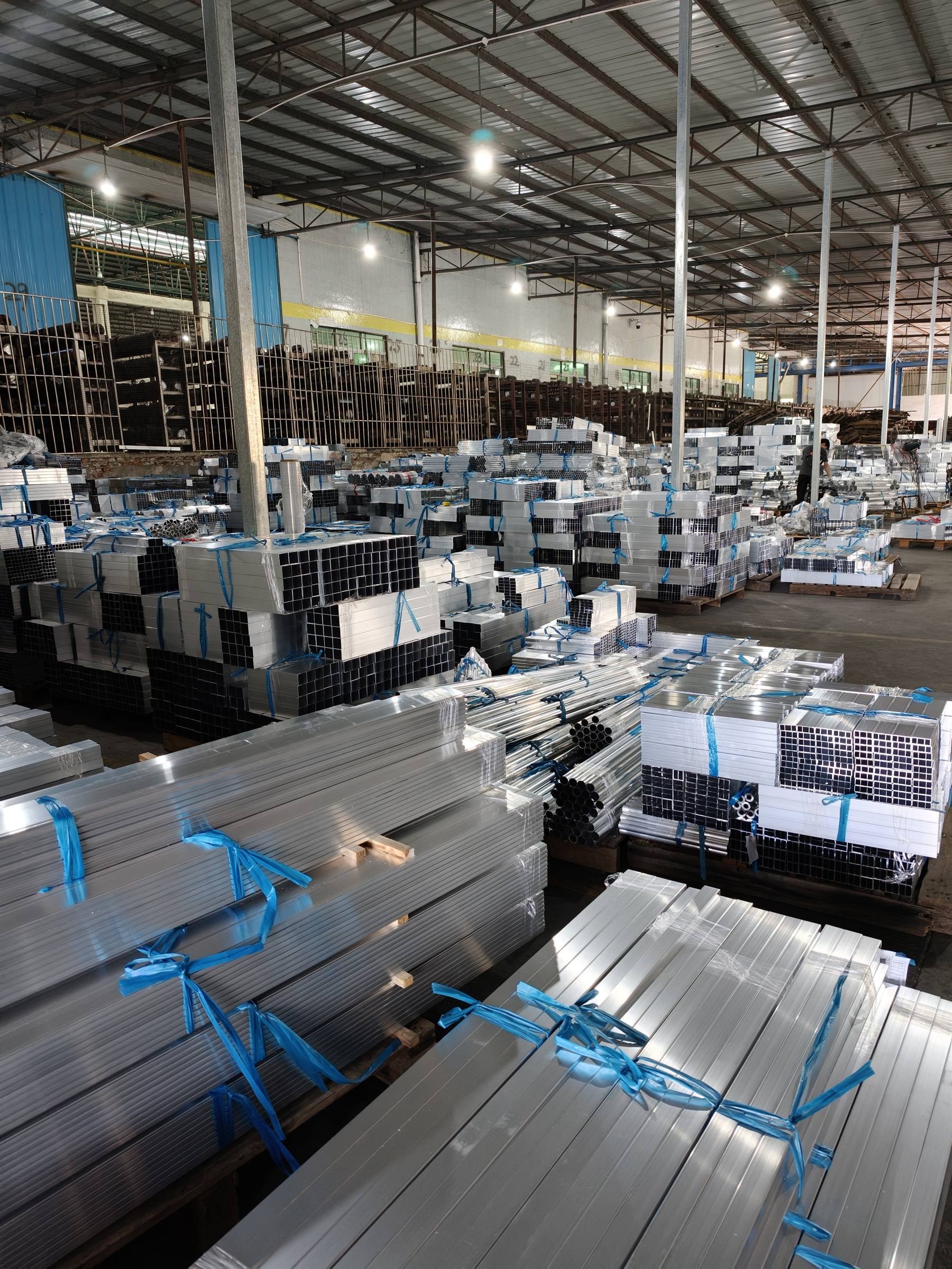 Bundles of mill-finish aluminum square tube and profiles in the warehouse